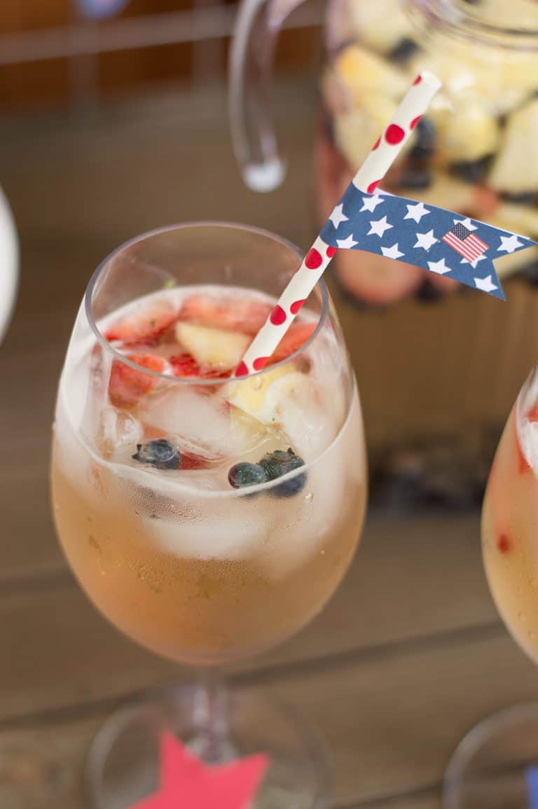 Ros&eacute;, White, and Blueberry Sangria with 4th of July Straw Flag