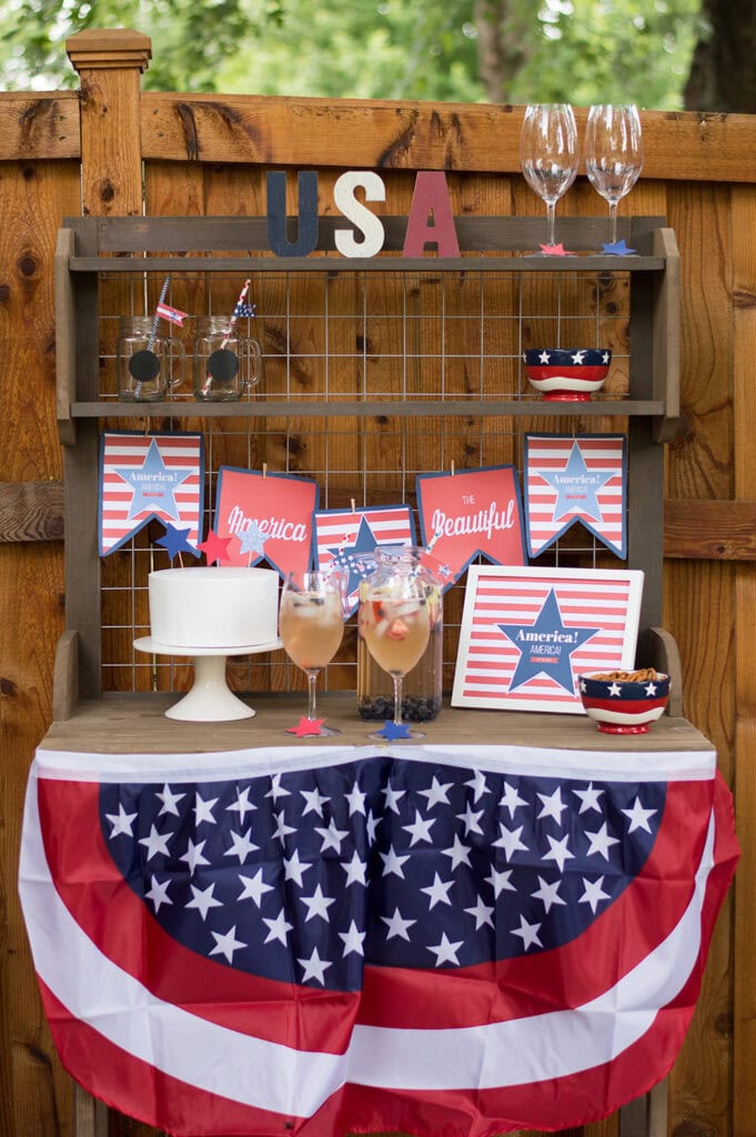 Backyard potting table decorated for the 4th of July with flag bunting, styled with free 4th of July printables