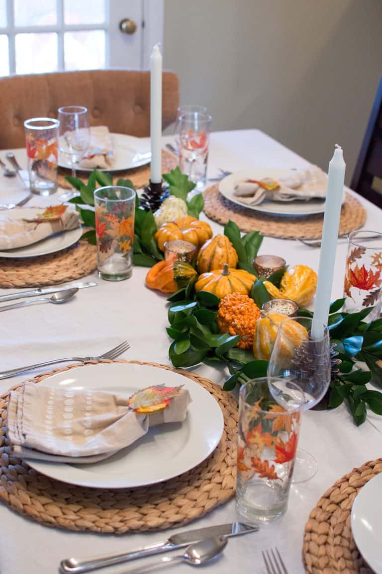 Loving the pop of color of the centerpiece against the neutral place settings on this Thanksgiving Tablescape