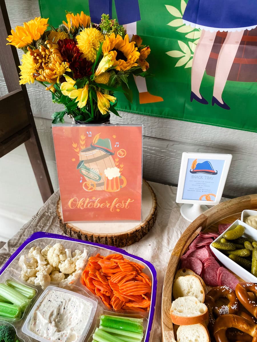 Oktoberfest printable barrel sign next to sunflower centerpiece at an adult Oktoberfest party