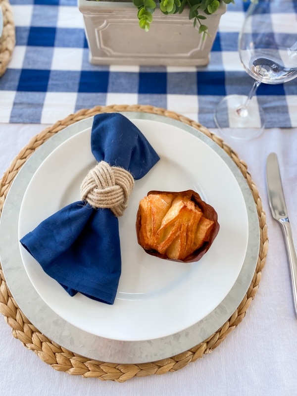 Place setting with blue linen napkin and nautical napkin ring