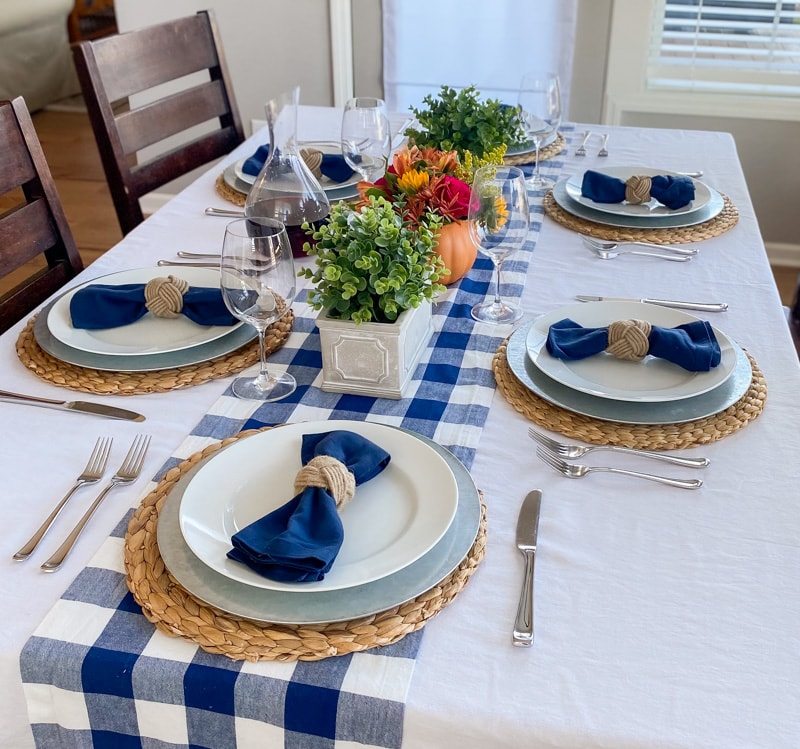 Thanksgiving table with bright florals, greenery, and blue accents
