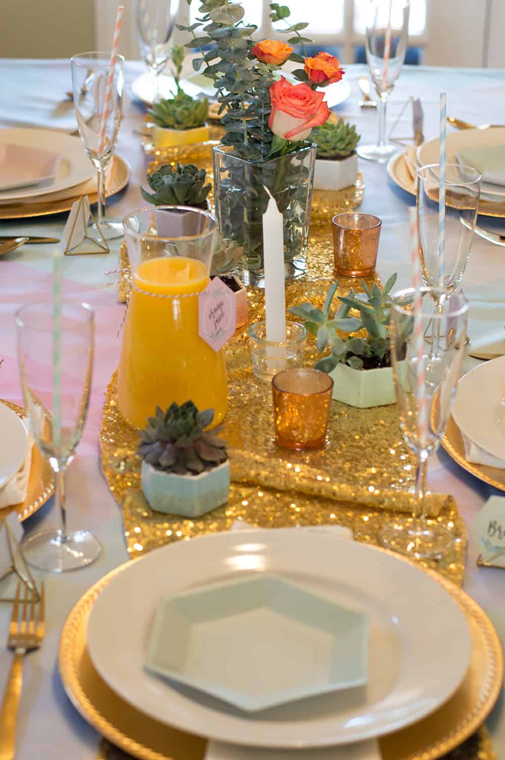 Flowers, succulents, and candles create a simple yet breathtaking centerpieces, especially when layered on top of gold.