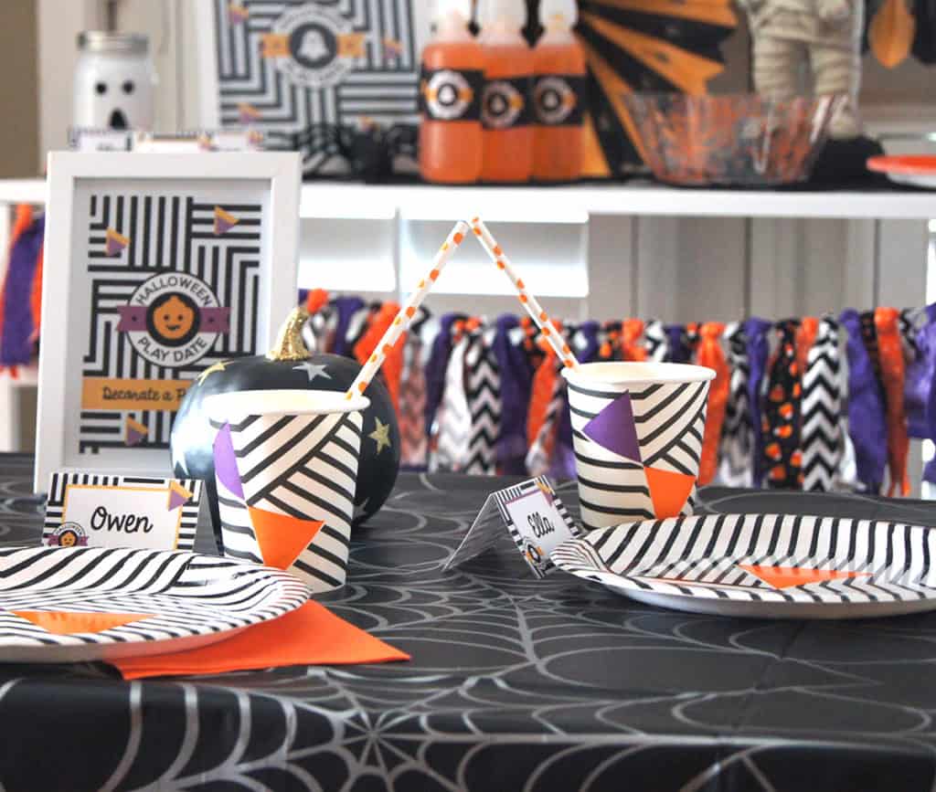 Halloween play date table setting with party supplies from Sprinkles & Confetti. Grab the free printables at elvamdesign.com.