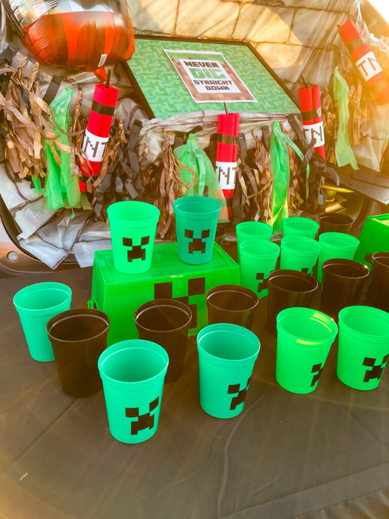 Minecraft trunk or treat Creeper Cup game with green and black cups and TNT balloon in the background